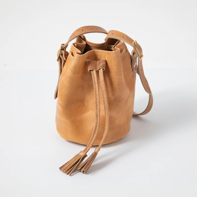 Suede Bucket Bag in Burgundy with Tassel Trim for a Boho - Chic VibeNatural Derby Bucket Bag